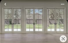 an empty room with french doors and windows