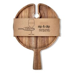 a wooden paddle with a wine glass on it and a cardboard tag hanging from the handle