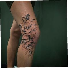 a woman's leg with a flower tattoo on her left calf and the lower half of her leg