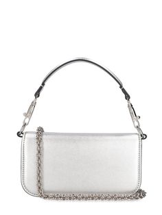 Find VALENTINO Locò Top Handle Bag on Editorialist. The VALENTINO GARAVANI Locò Top Handle Bag features a metal chain strap, a detachable leather top handle, and a front flap closure with a metal logo detail. The bag measures 11cm in height, 20cm in width, and 5cm in depth. The strap drop is 51cm and the handle drop is 11cm. Silver Shoulder Bag With Top Handle And Chain Strap, Luxury Silver Shoulder Bag With Chain Strap, Silver Shoulder Bag With Chain Strap, Luxury Silver Bag With Chain Strap, Luxury Silver Bags With Chain Strap, Clutch Shoulder Bag With Silver-tone Hardware, Silver Leather Bag With Chain Strap, Silver Crossbody Shoulder Bag With Chain Detail, Silver Crossbody Shoulder Bag With Chain