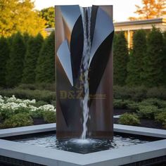 a large water fountain in the middle of a garden