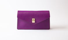 Orchid/Olive|Front View Formal Envelope Bag With Gold-tone Hardware, Elegant Purple Wallets For Travel, Formal Envelope Bags With Gold-tone Hardware, Timeless Rectangular Wallet On Chain For Everyday Use, Elegant Purple Clutch For Everyday Use, Elegant Everyday Purple Wallets, Elegant Purple Everyday Wallet, Luxury Everyday Envelope Shoulder Bag, Purple Clutch Shoulder Bag For Formal Occasions