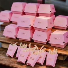 many pink boxes are stacked on top of each other in order to be used as favors