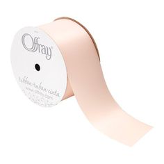 a roll of pink satin ribbon with the word ohay printed on it, in white