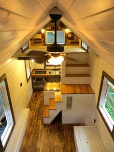 the interior of a tiny house with stairs leading up to it's second floor