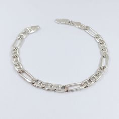 Figarucci Chain Bracelet - Silver 925 Solid Figaro Unisex Chain Bracelet - 5 mm by Brilho. Is 5 mm thick, 8.5'' (22 cms) of length and weights aprox. 14.2 grs. Real SOLID Silver only. Ideal for everyday use. Elegant made in Italy only style. Figaro style chain plus 'cci links. Contact us if you need more information. Free shipping within the US. Product made in Italy. We follow Etsy's return and exchange policy for 30 days. If you have your business and want to do wholesale with the Brilho products, contact us. We're manufacturers. #revealyourinnerbeauty ---- Pulsera estilo Figarucci - Figaro de Plata 925 marca Brilho de 5 mm de espesor o grosor, 22 centimetros (8.5 pulgadas) de longitud y peso de 14.2 gramos. Es plata pesada solida y real. Ideal para uso cotidiano. Estilo elegante y único Hallmarked Sterling Silver Link Bracelet, Classic Silver Figaro Chain Bracelet, Silver Bracelet With Figaro Chain And Oval Link, Formal Silver Bracelet With Figaro Chain, White Gold Sterling Silver Bracelets With Figaro Chain, White Gold Sterling Silver Figaro Chain Bracelets, White Gold Sterling Silver Bracelet With Figaro Chain, Silver Figaro Chain Bracelet As Gift, Bracelet Box