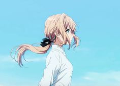 a girl with long hair standing in front of a blue sky and looking at something