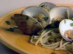 an assortment of food on a wooden plate with utensils and spoons in it