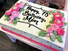 a white cake with pink flowers on it and the words happy 75th birthday mom