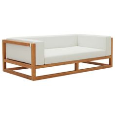 a white couch sitting on top of a wooden frame