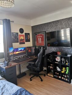 a room with a desk, computer and other items in it