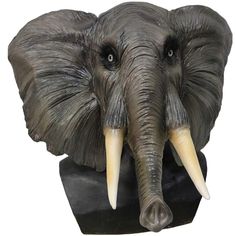 an elephant's head with tusks is shown in front of a white background