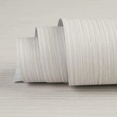 two rolls of white thread on top of each other