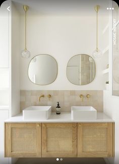 two white sinks sitting under mirrors in a bathroom next to a wall mounted faucet