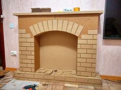 a brick fireplace being built in a living room