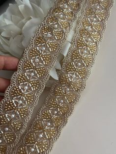 Embellish your designs with this stunning embellished pearl trim  that combine beautiful Glass bead accents. The Beautiful Hand Made Fringe Is Gothic and perfect for costume designers and add a touch of grandeur and opulence to your attire.  We are constantly adding new items and you will be sure to find our complete inventory with 1000's of designs at www.lacetrimssindia.com PLEASE NOTE : ALL ORDERS ARE SHIPPED FROM THE INDIA RETURN POLICY *All broken case can be re-sent or refund if the condition is proven by photo . *Exchange item or refund case can be accepted within 5 days after receiving the item. Return shipping charge is pay by buyer if it is not our fault. SHIPPING *All postage provide tracking number *Delivery Time : 10 - 20 business days normally but may be sometimes about 1 mon Elegant Gold Embroidered Bridal Belt, Elegant Pearl Embroidered Fabric For Celebration, Elegant Embroidered Fabric With Border For Parties, Gold Embroidered Trims For Wedding, Gold Embroidered Wedding Trims, Elegant Embroidered Trims For Festive Occasions, Elegant Festive Trims With Embroidered Border, Festive Gold Embellished Bridal Belt, Gold Embellished Bridal Belt For Festive Occasion