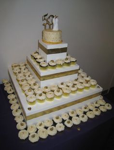 a wedding cake with lots of cupcakes on it