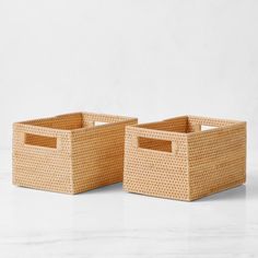 two wicker baskets sitting on top of a white counter