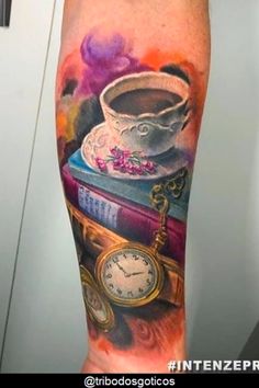 an arm tattoo with books and a clock on it, including a cup of coffee