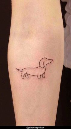 a small dachshund tattoo on the leg