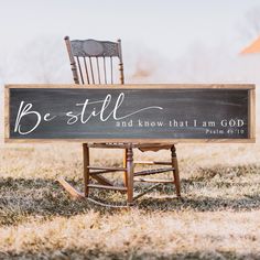 a wooden sign that says be still and know that i am god is on top of a rocking chair