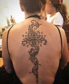 a woman with a tattoo on her back