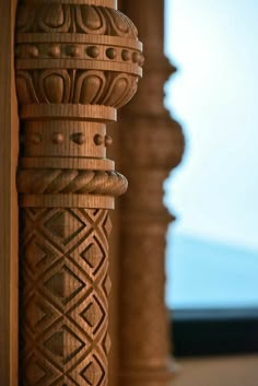 a close up view of an intricately carved wooden column with decorative carvings on it