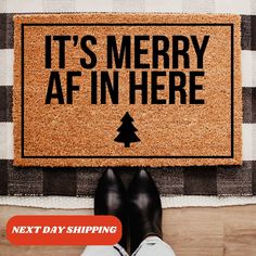 someone is standing in front of a door mat that says it's merry afin here