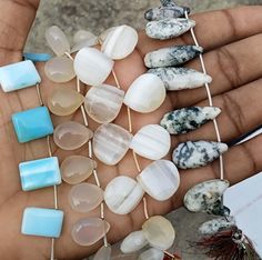 several different types of sea glass on a person's palm