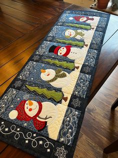 the table runner has snowmen on it