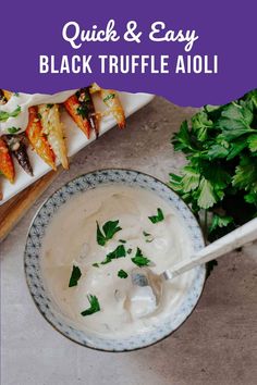 a bowl filled with white sauce and garnished with parsley on the side