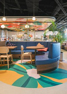 a restaurant with circular seating and colorful flooring