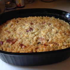 a casserole dish with meat and cheese in it sitting on a counter top