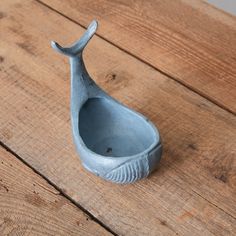 a small blue vase sitting on top of a wooden table