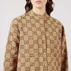 "Find GUCCI Maxi Gg Canvas Shirt, It Ready-to-wear on Editorialist. Instantly recognizable emblems of the brand, logos enrich designs in new and unexpected ways. Behind every logo lies the tradition and value of the House, an everlasting medium one can wear again and again. Following the idea of constant change and experimentation, different iterations of the logo have been presented each collection. The maxi GG, a new version of the historic monogram, animates this shirt. Camel and ebony maxi G Brand Logos, Gucci Tote, New Version, Beauty Items, Online Purchase, Stand Up, Camel, Top Shirt, Ready To Wear