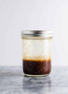 a jar filled with liquid sitting on top of a counter