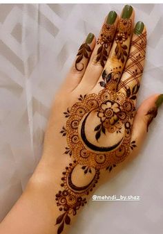 a woman's hand with henna on it