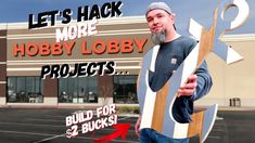 a man holding a large wooden object with the words let's hack more hobby lobby projects