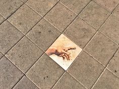 a square piece of artwork on the ground