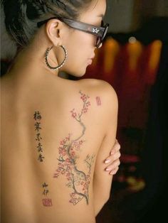 a woman with tattoos on her back