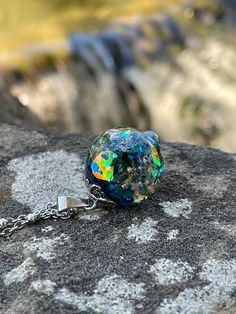 This is a unique blue mixed medium resin orb necklace! I used rainbow translucent pieces, multi color glitter chunks, gold and silver flakes to create this pendant! This necklace is a unique with a lot of shine and different looks from different angles! This would be a great addition to your collection or as a special gift! Check out my page for the matching ring! This pendant comes in two sizes (Medium 1.25 tall by .75 wide) or (Large 1.50 tall by 1 wide) (Please choose your size at checkout) T Silver Resin Necklaces For Parties, Glitter Round Jewelry As Gift, Silver Resin Jewelry With Magical Style, Round Glitter Jewelry As Gift, Glitter Resin Jewelry As A Gift, Glitter Resin Jewelry For Gift, Round Glitter Jewelry For Gifts, Resin Jewelry With Glitter For Gift, Magical Silver Resin Jewelry