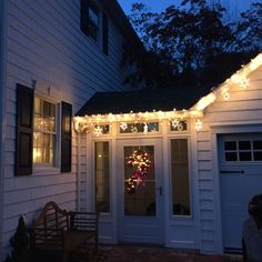 a house with christmas lights on the front door