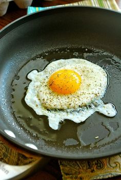 an egg frying in a skillet on top of a table