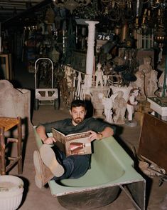 a man sitting in a chair holding a box