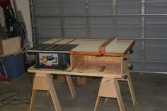 a workbench with a router on it in front of a garage door