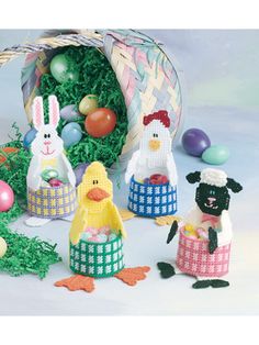 an easter basket filled with crocheted eggs and bunnies, some decorated like chickens