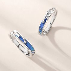 two silver rings with blue and white enamel inlays on top of each other