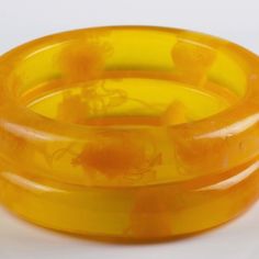 Two Orange, Crackled Bangles Of Bakelite. Circa 1950's. Bracelets Are Almost 5/8” Wide. Each Bracelet Has An Internal Diameter Of 2 5/8”. Tested With Semi-Chrome. Nice To Match With Your Green Or Yellow Ensemble. Vintage Orange Bangle Bracelets, Vintage Orange Bracelets As Gifts, Vintage Yellow Round Bracelets, Retro Yellow Bangle Bracelets, Retro Yellow Bangle Bracelet, Yellow Retro Bracelet As Gift, Yellow Vintage Bracelet As Gift, Handmade Vintage Yellow Bracelets, Yellow Bangle Bracelets For Formal Occasion