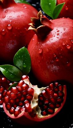 pomegranates with leaves and water droplets on them