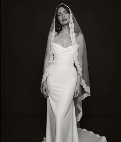 a woman in a wedding dress and veil